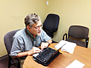 Roger Baker works to verify petition signatures