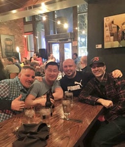 Suk Kimwhitty (center left) and Jack Lumus (center right) in bar with friends